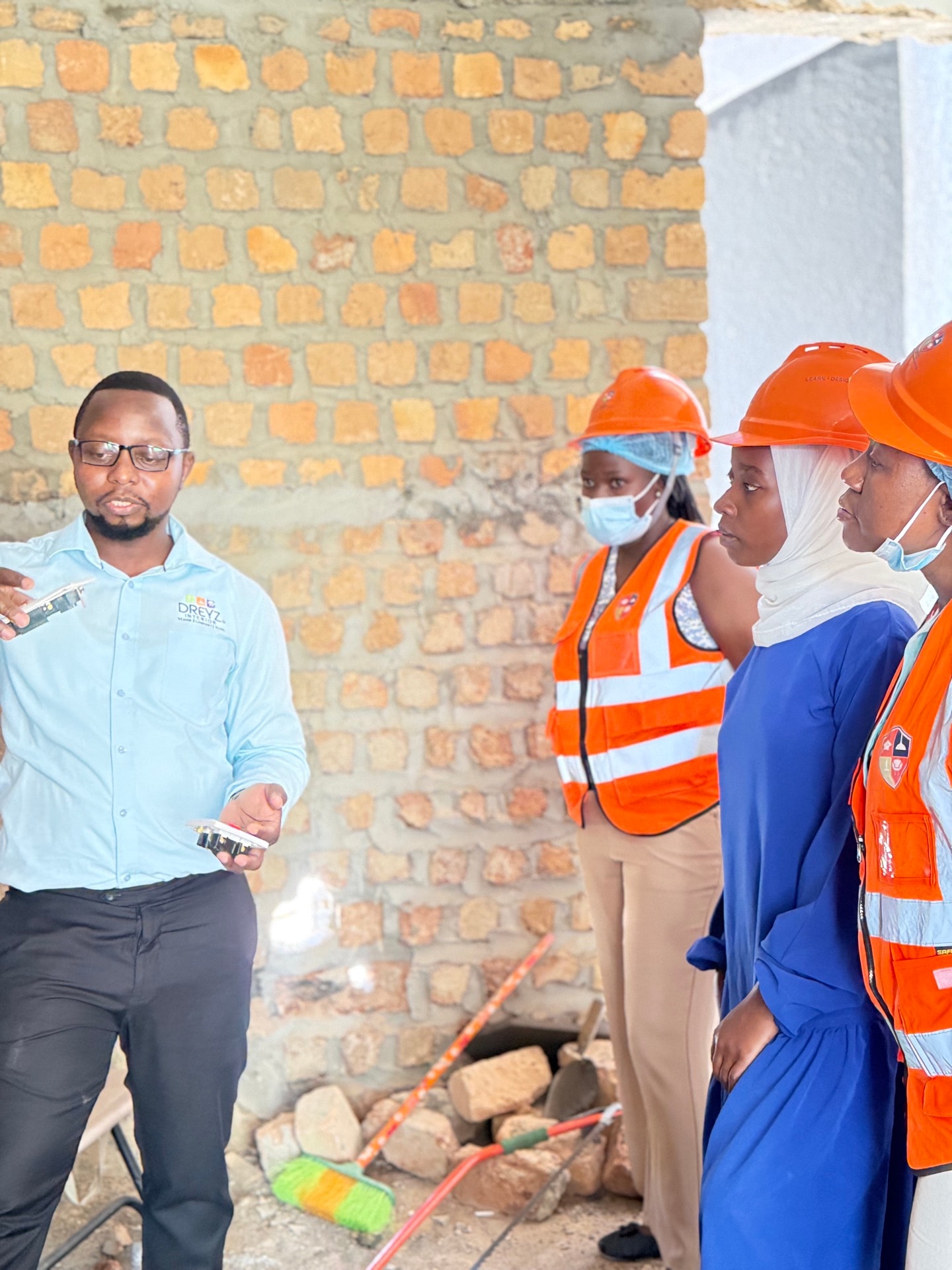 A Dreyz instructor explaining fittings to students on a site visit